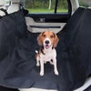 shows a small dog seated in the rear of a car on the Crufts Car Hammock