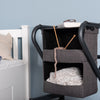 The image shows the bedside cabinet with personal items in the compartments, including knitting and with a book and glasses on the top of the rollator cabinet
