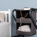The image shows the bedside cabinet with personal items in the compartments, including knitting and with a book and glasses on the top of the rollator cabinet