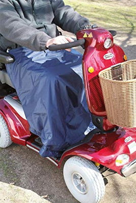 A person in a mobility scooter using a scooter leg cape