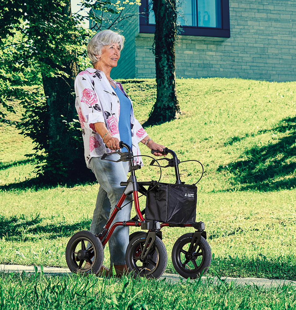 shows a woman using the Dietz Taima Rollator XC