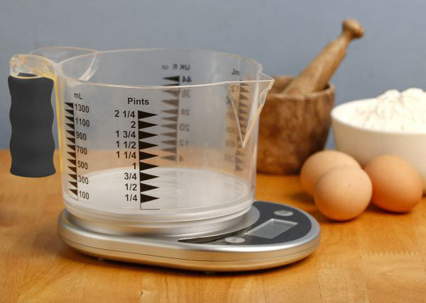 The Kitchen Talking Scales with measuring jug on a kitchen table