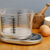 The Kitchen Talking Scales with measuring jug on a kitchen table