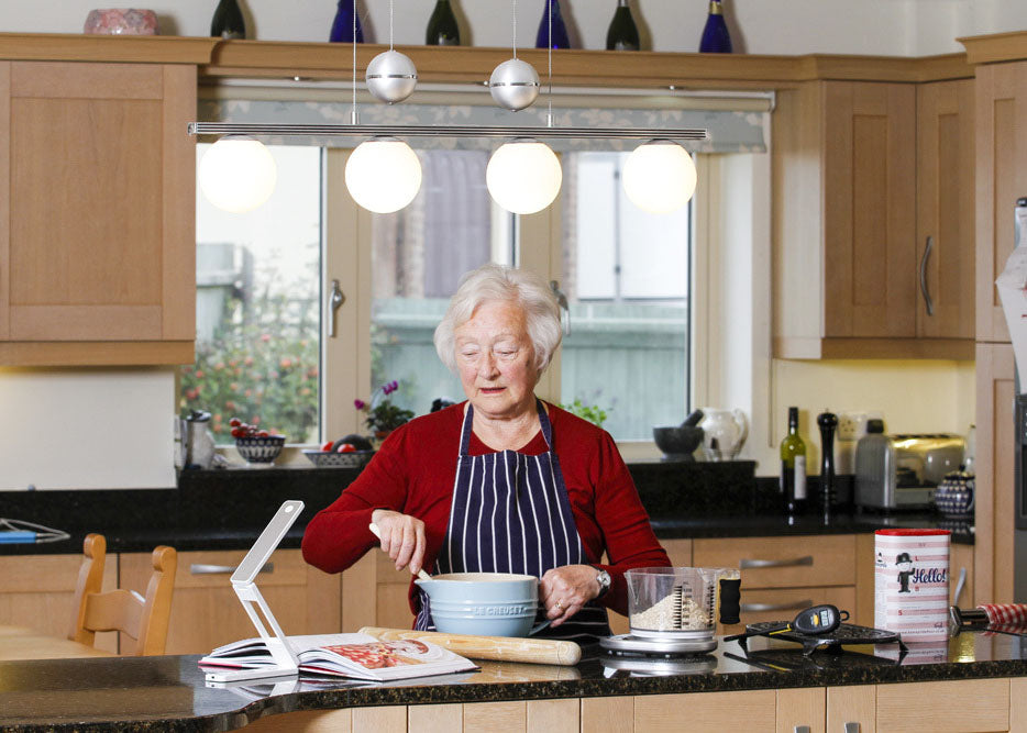 a woman using the talking kitchen scales in her kitchen