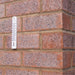 Outdoor thermometer mounted on external brick wall
