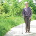 the image shows a lady using a folding coloured walking stick