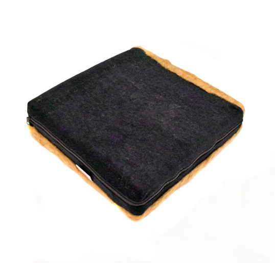 A zipped up 100% wool pile cushion