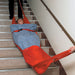 Two medical employees using the Evacuation Sledge to move someone on some stairs